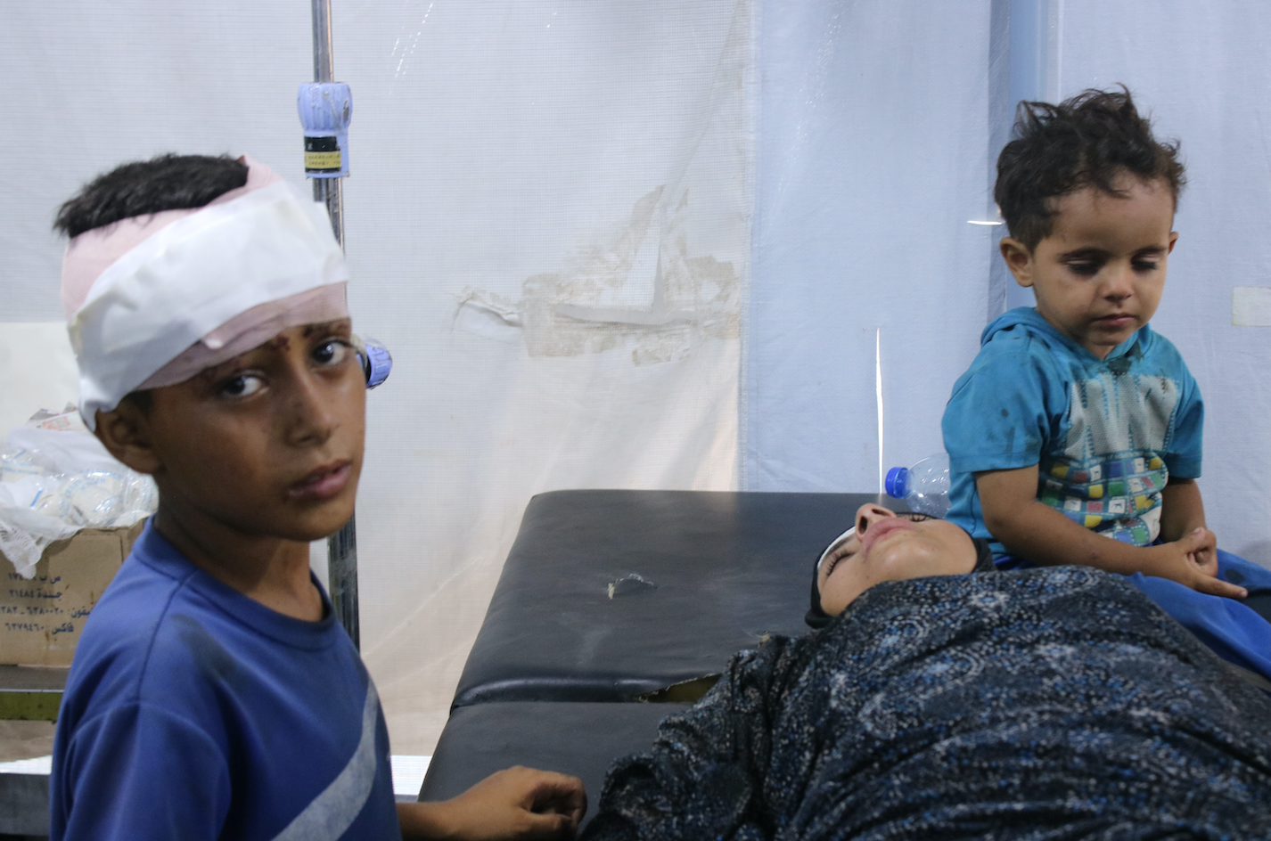 أطفال مع والدتهم أصابهم القصف الإسرائيلي لمدرسة الرازي للنازحين